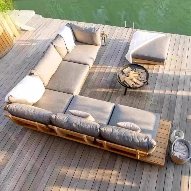 Outdoor sectional sofa on a wooden deck by a body of water