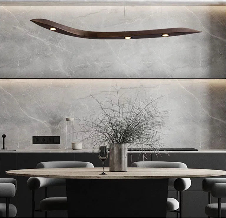 Modern kitchen with marble backsplash, round dining table, and decorative elements.