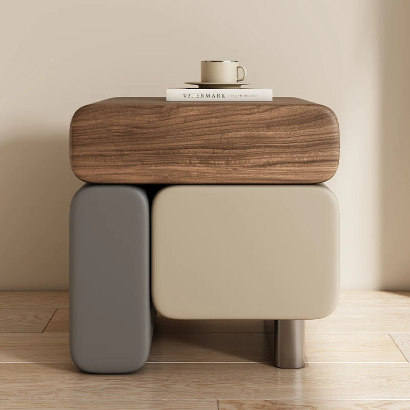 Modern side table with wooden top and gray base on a wooden floor.