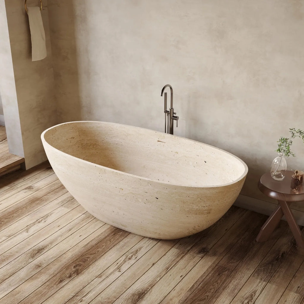 Modern bathroom with a freestanding stone bathtub on a wooden floor.