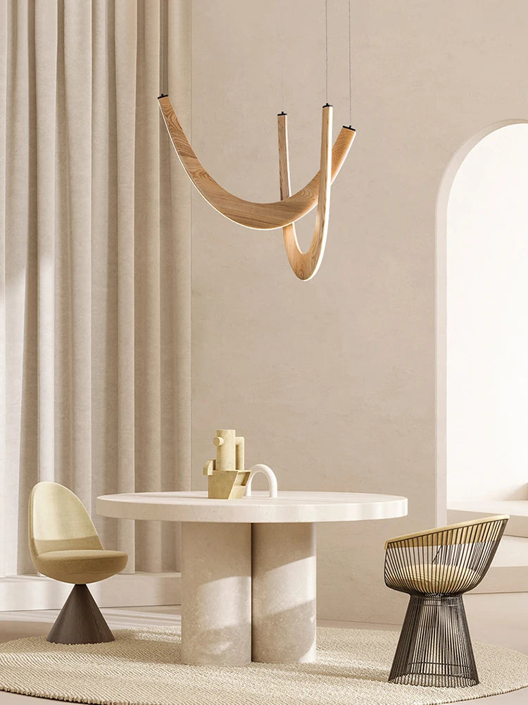 Modern dining room with a marble table, chairs, and a hanging light fixture.