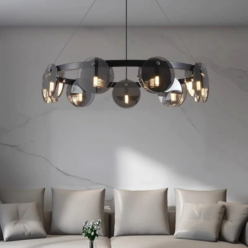 Modern chandelier hanging above a sofa in a living room setting.