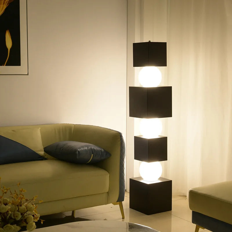 Modern floor lamp in a living room setting with a sofa and decorative elements.