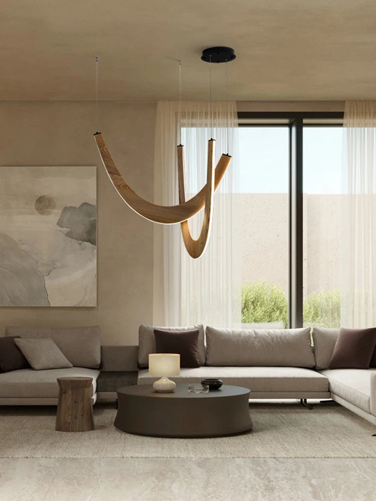 Modern living room with a chandelier, sofa, and coffee table.