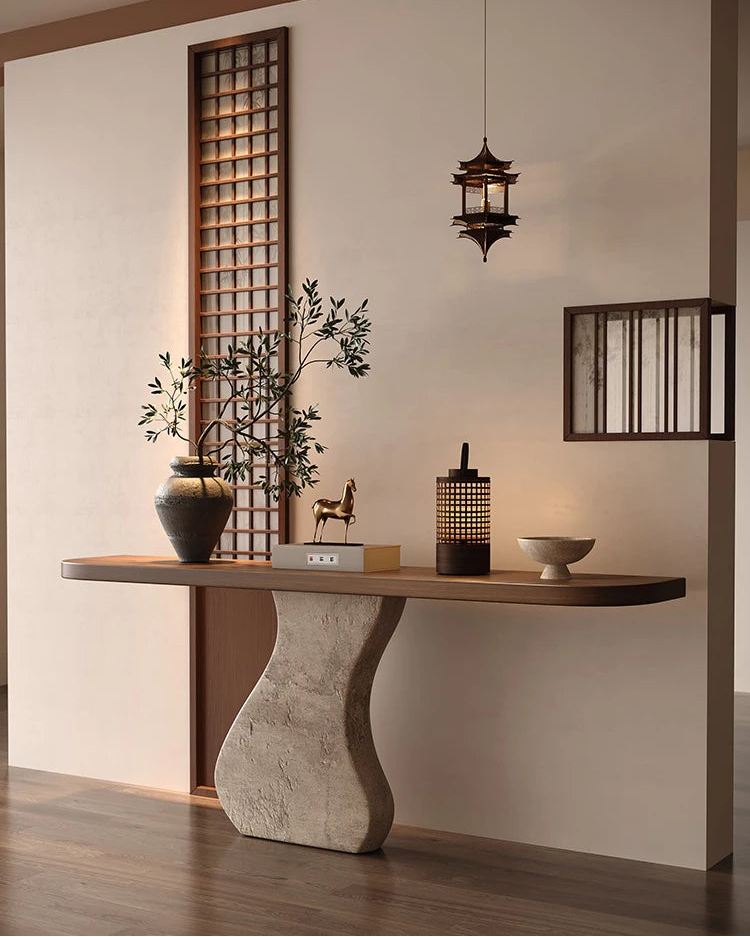 Modern interior design with a wooden console table, decorative items, and a hanging light fixture.