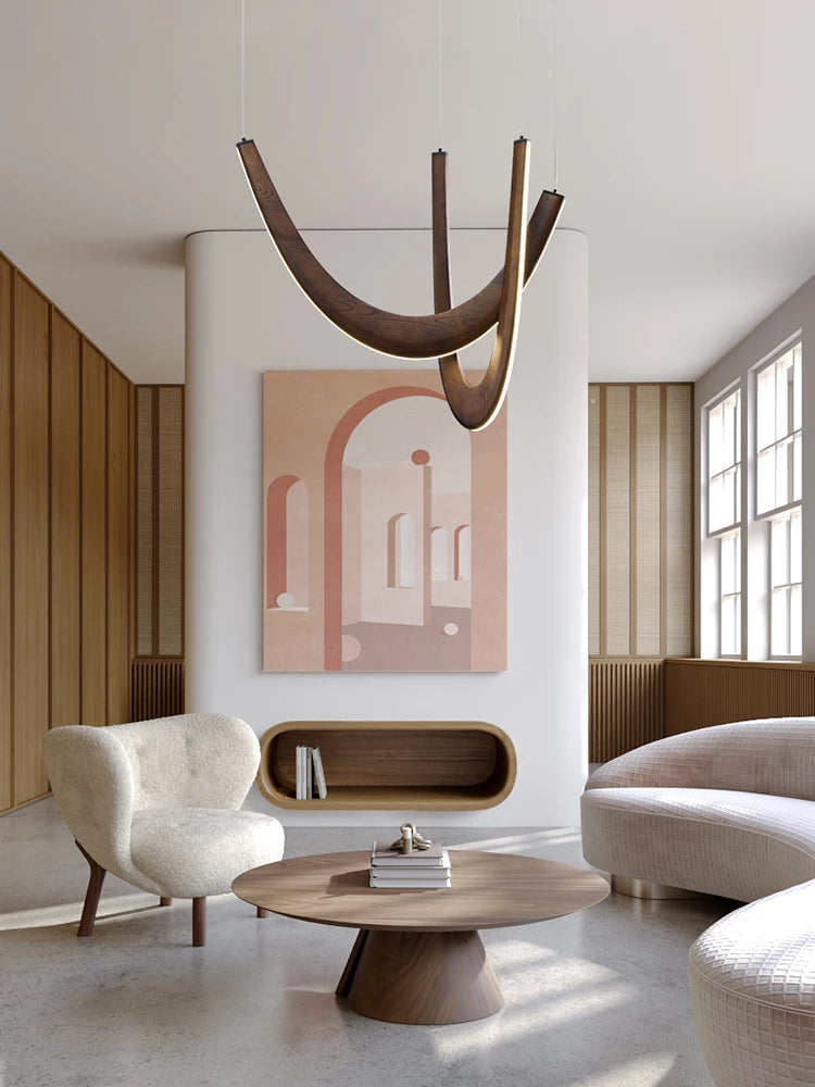Modern living room with a chandelier, armchair, coffee table, and abstract painting.
