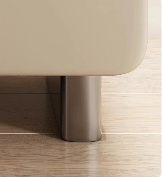 Beige stool with metal leg on a wooden floor, featuring text about durability and stability.