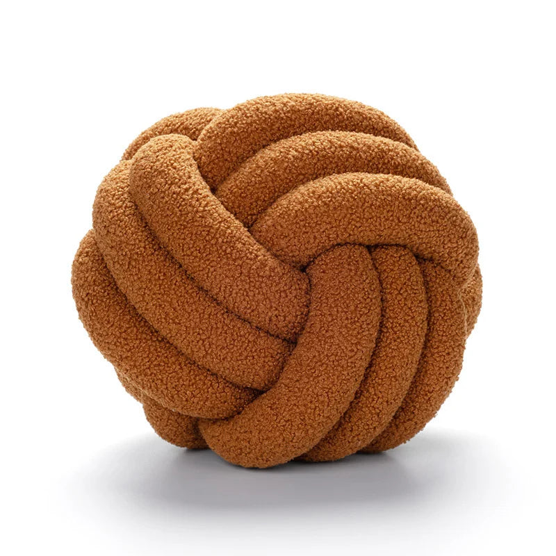 Brown knotted ball toy on a white background