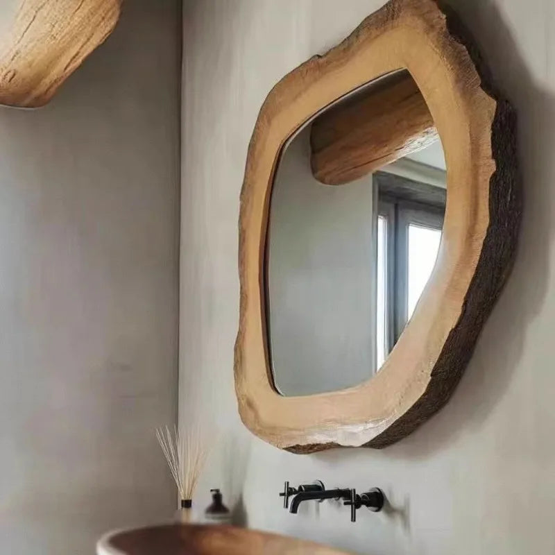 Wooden mirror with natural edge design on a wall.