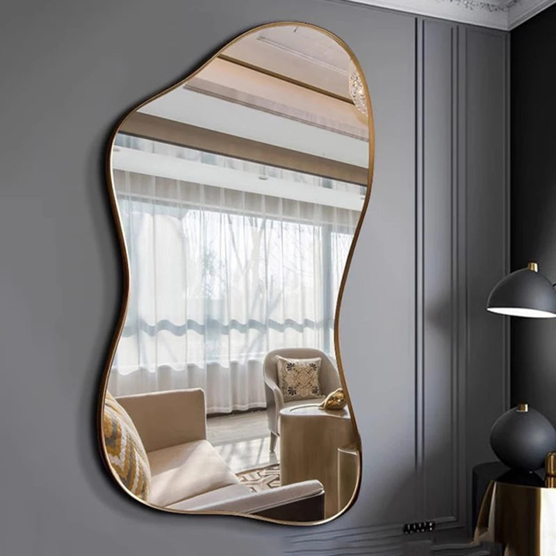 Decorative wall mirror with wavy frame reflecting a living room.