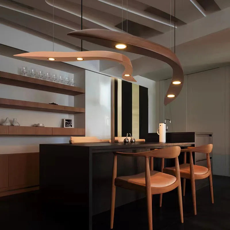 Modern kitchen with wooden chairs and a unique ceiling light fixture.