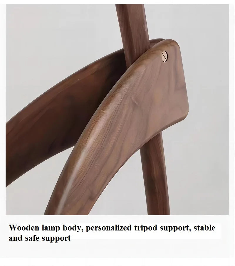 Wooden lamp body with personalized tripod support on a light gray background