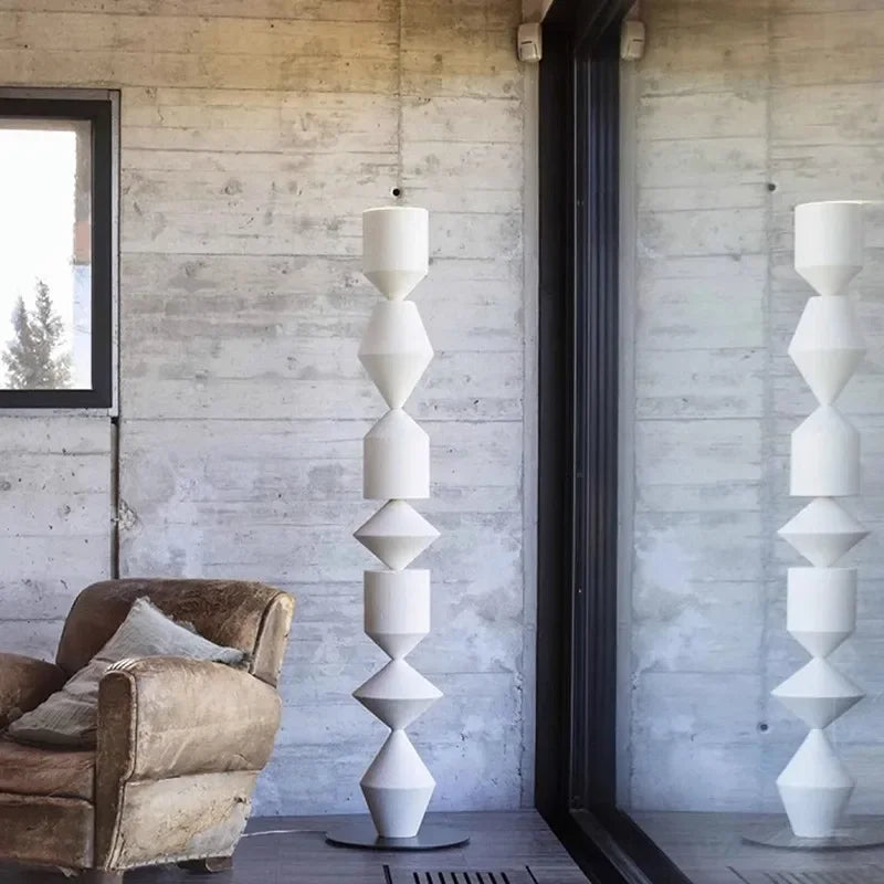 Modern interior with a unique floor lamp against a wooden wall.
