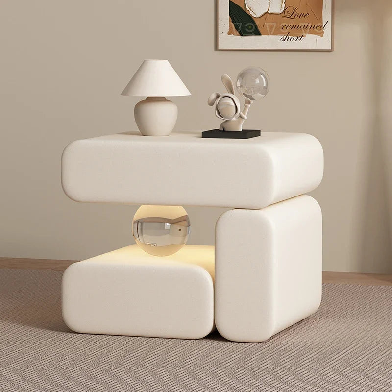 Modern white side table with decorative items in a room setting