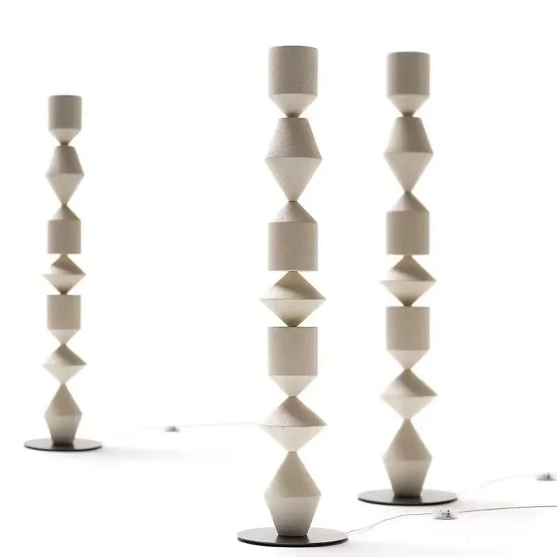 Two modern floor lamps with geometric design on a white background