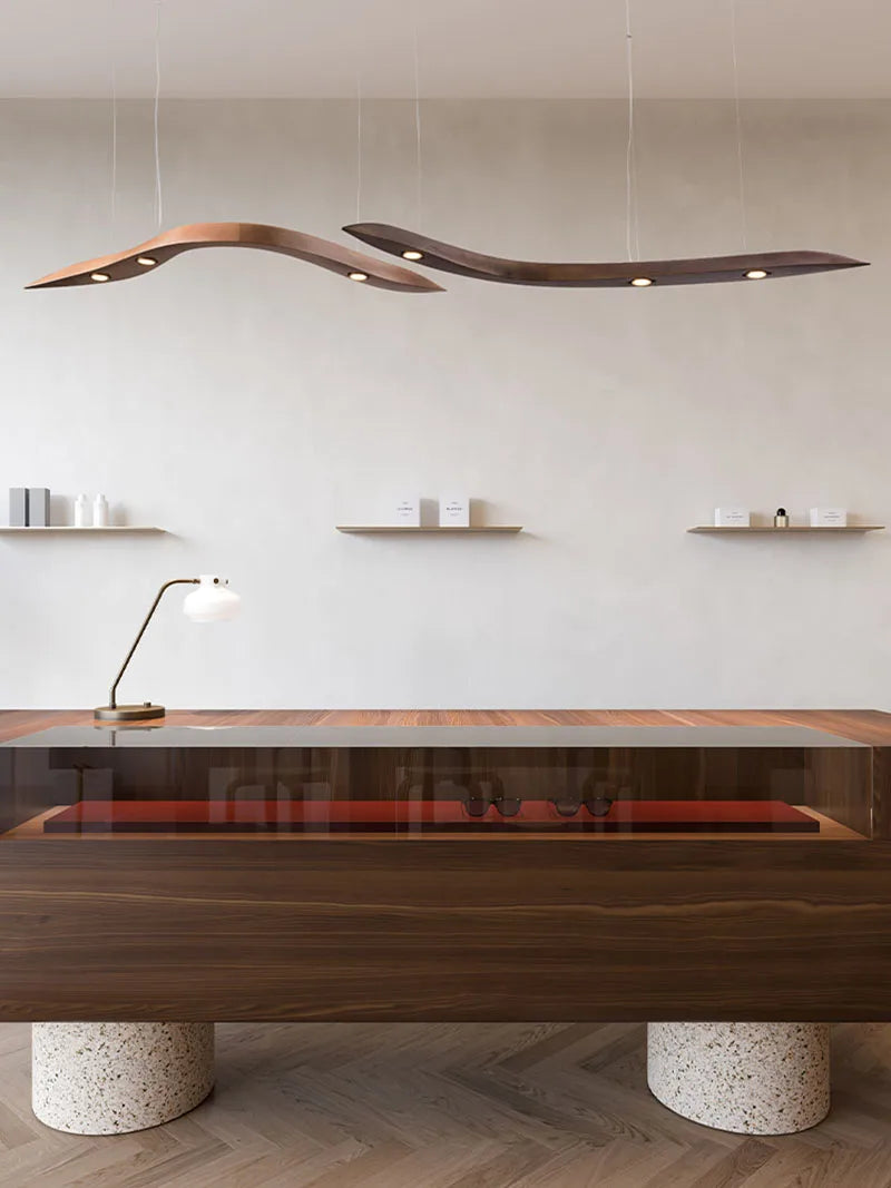 Modern office desk with wooden finish and marble base in a minimalistic room.