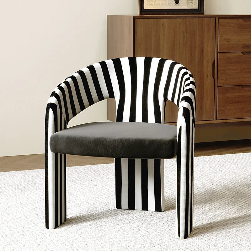 Chair with black and white striped backrest and gray seat in a room setting.