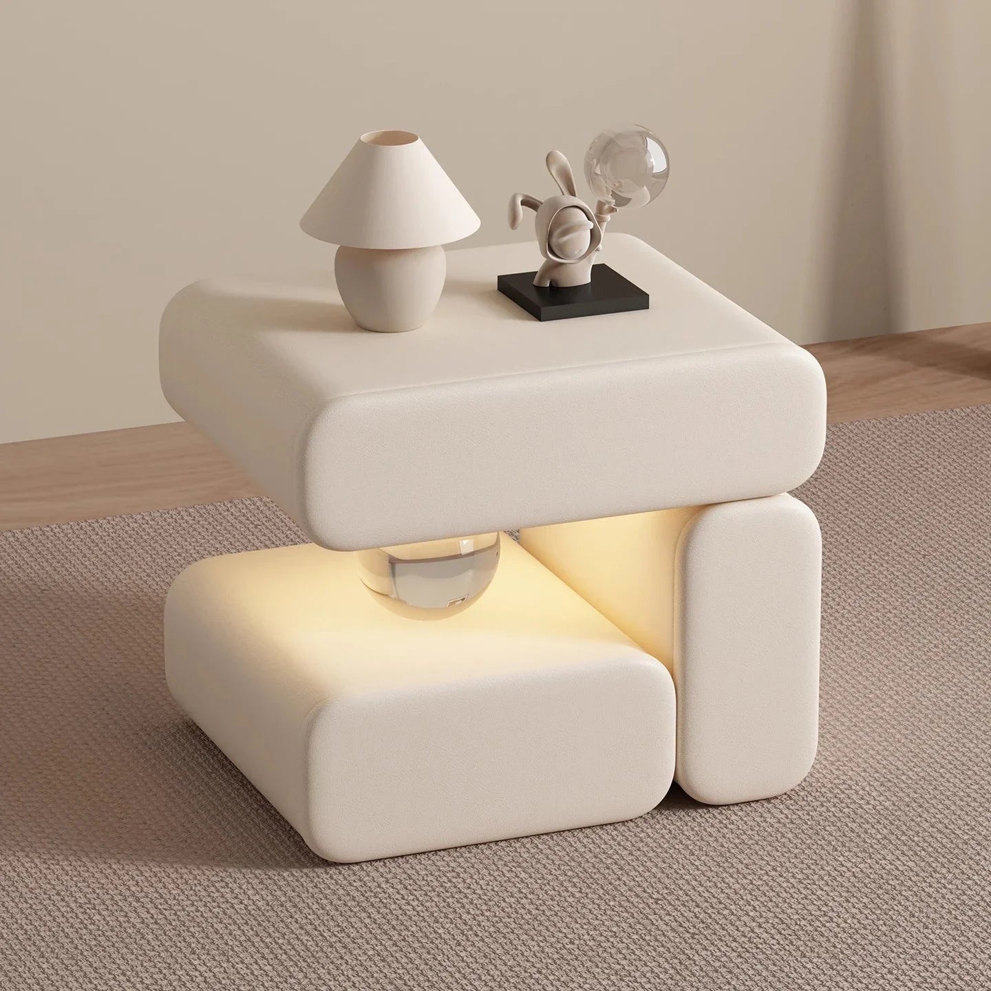 White nightstand with a lamp and decorative items on a wooden floor.