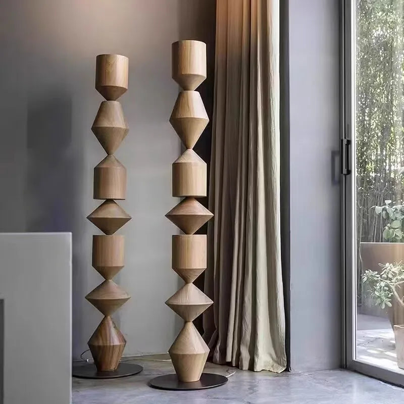 Modern interior with a unique wooden floor lamp and large window.
