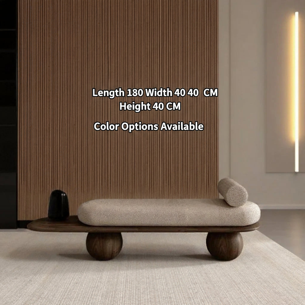 Modern bench with wooden legs and beige cushion in a minimalistic room.