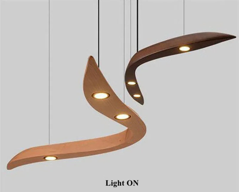 Modern pendant lights with wavy design on a plain background