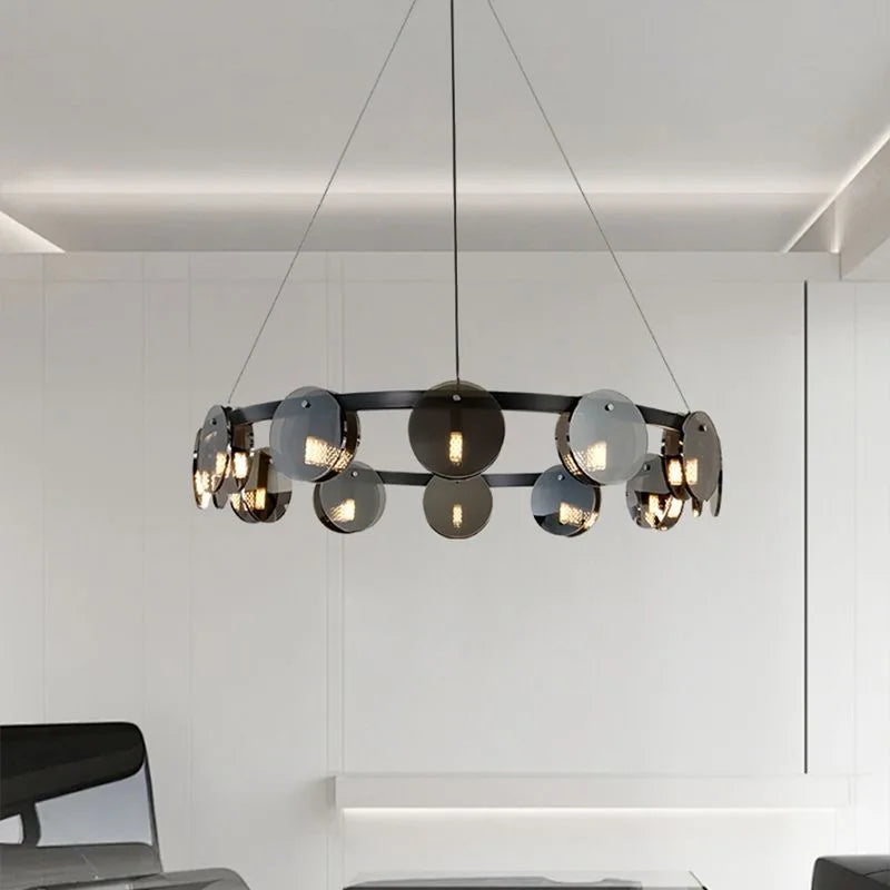 Modern chandelier hanging in a room with white walls and ceiling.