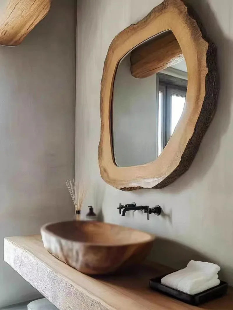 Bathroom with wooden sink and mirror, featuring a minimalist design.