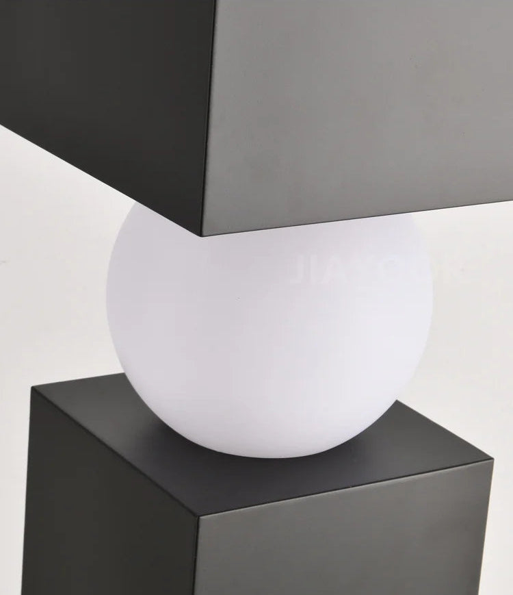 Acrylic lampshade on a black geometric base with a white background