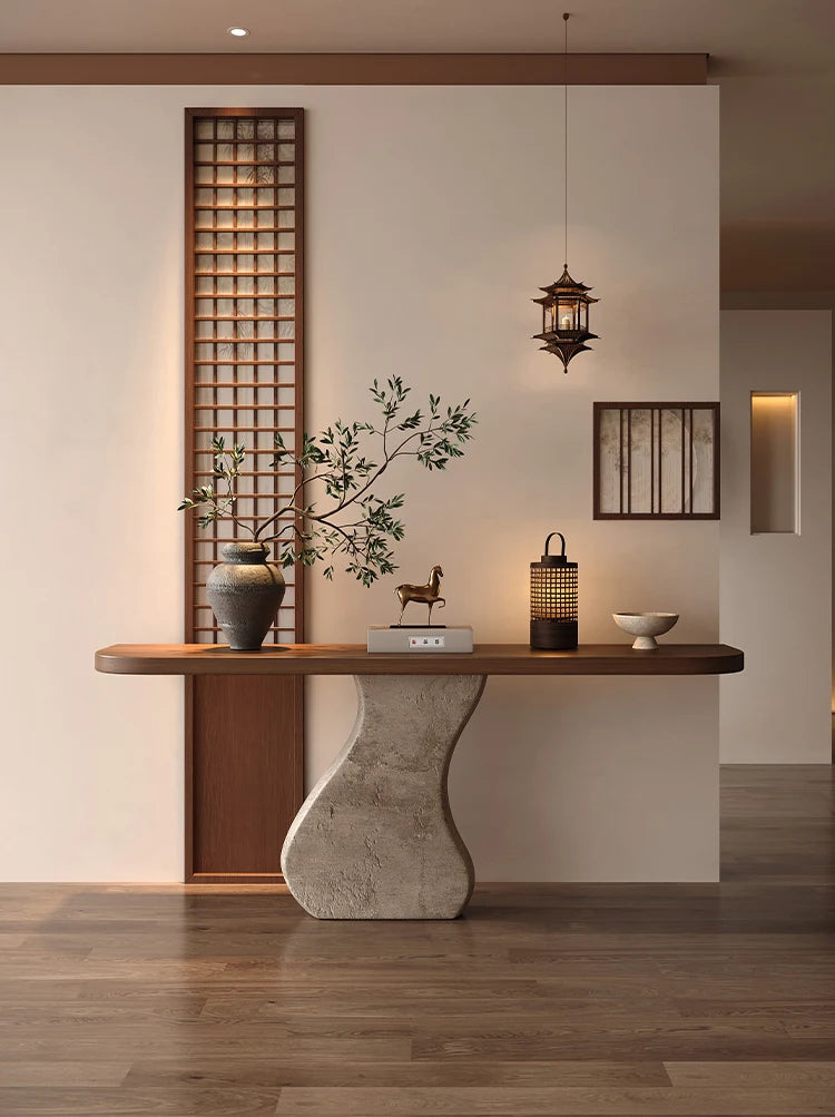 Modern interior design with a wooden console table, decorative items, and a wall panel.