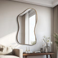 Modern wall mirror with wavy frame on a neutral wall