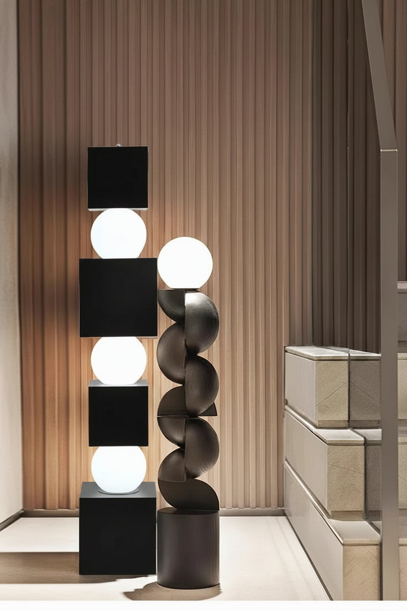 Modern floor lamp with cylindrical design in a room setting.