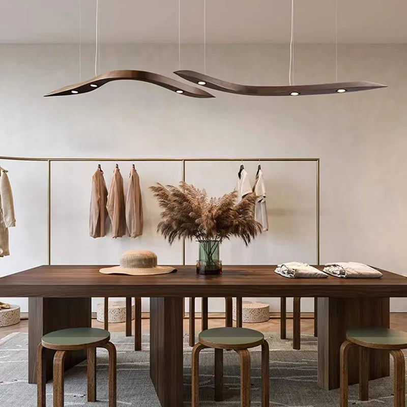Modern dining room with wooden table, stools, and decorative elements.