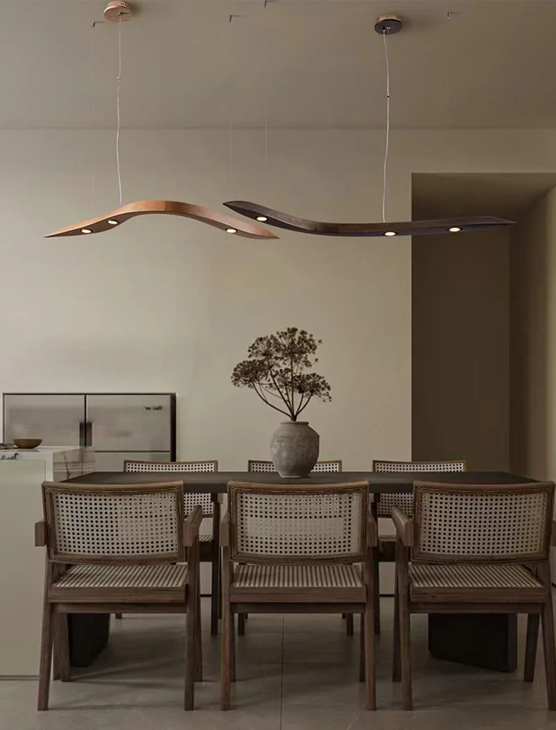 Dining room with a modern chandelier, table, and chairs.