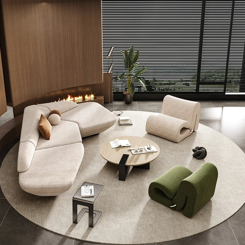Modern living room with a sectional sofa, round coffee table, and decorative items.