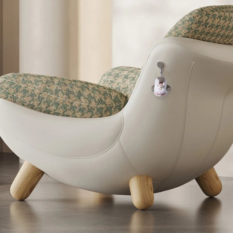 Modern chair with floral-patterned cushions and wooden legs on a neutral background