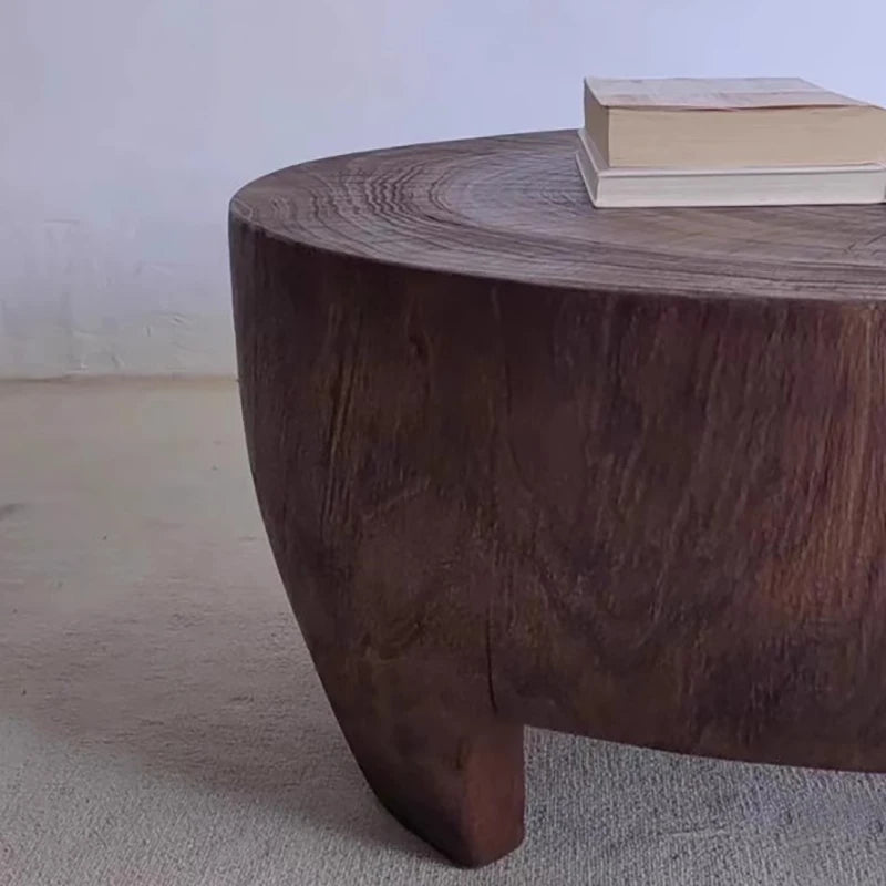 Wooden coffee table with a textured surface on a plain background