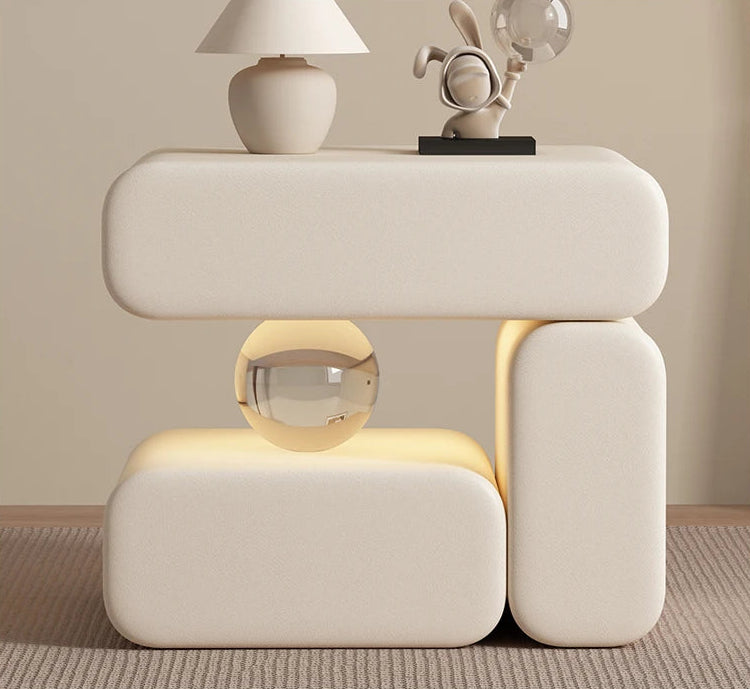 Modern side table with decorative items against a beige wall