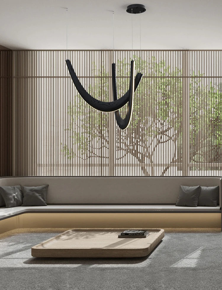 Modern interior with a hammock, sofa, and coffee table in a room with large windows.