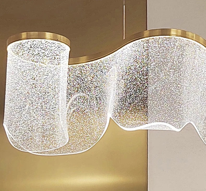 Modern chandelier with crystal-like design on a neutral background