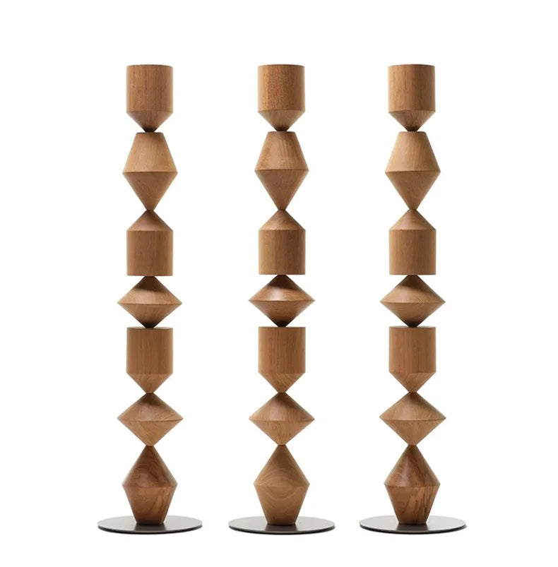 Three wooden candle holders with geometric designs on a white background