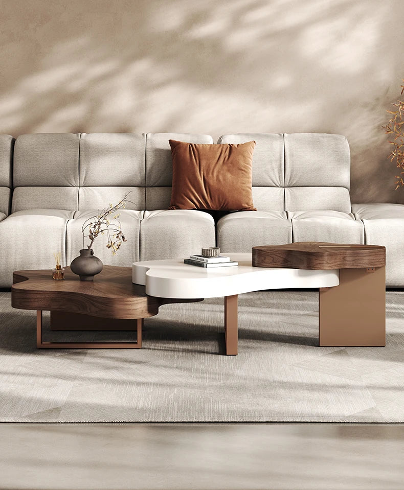 Gray sectional sofa with a brown pillow and wooden coffee tables in a living room setting.