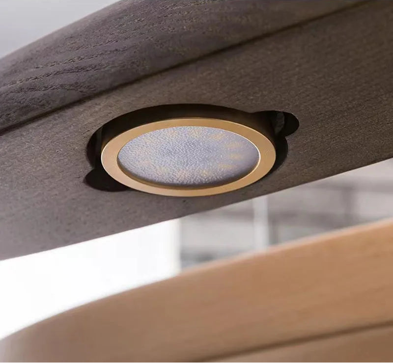 Ceiling light fixture embedded in a modern ceiling design.