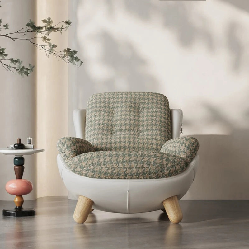 Patterned armchair with wooden legs in a room setting