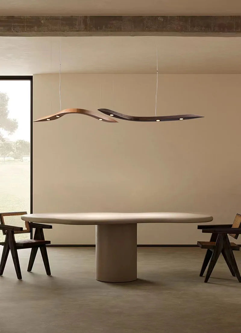 Modern dining room with a round table and stylish pendant light.