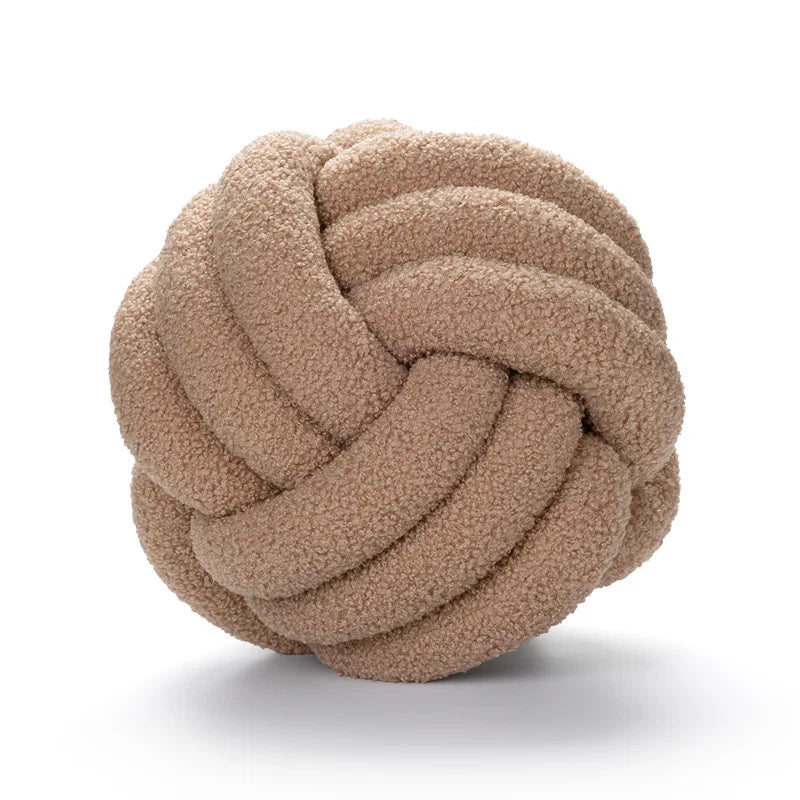Brown knotted ball toy on a white background