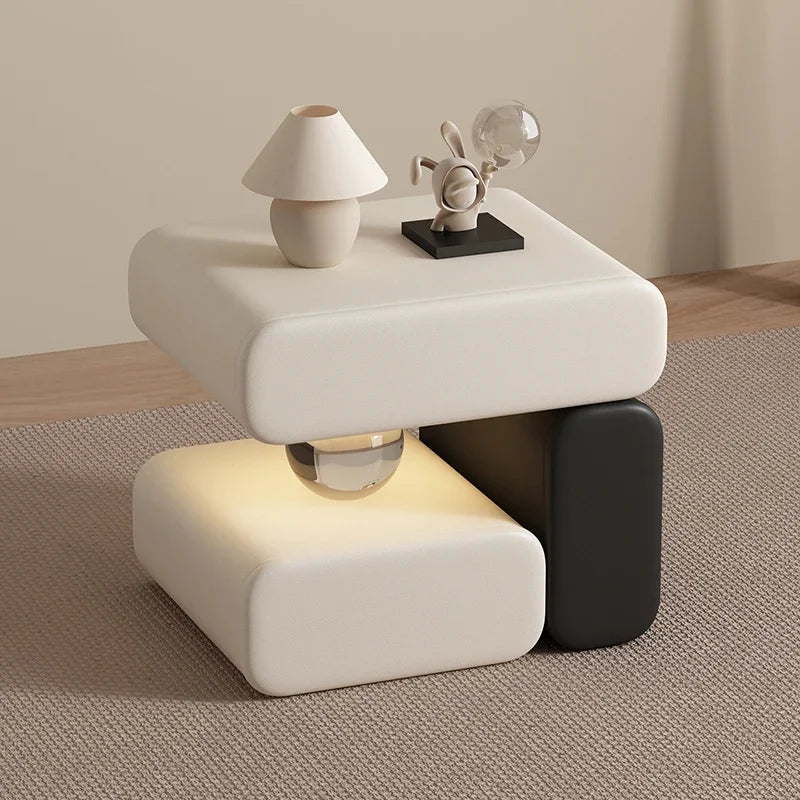 Modern side table with a lamp and decorative items on a neutral background