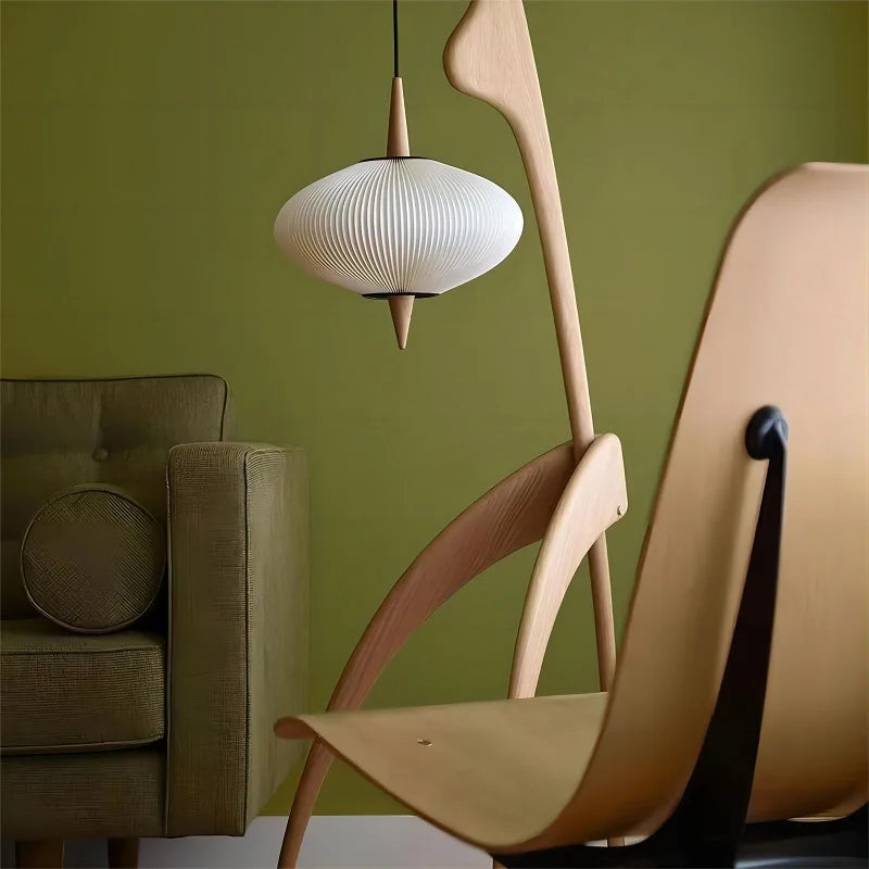 Modern chair and lamp against a green wall