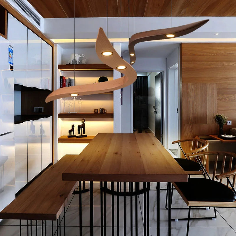 Modern dining area with wooden table and chairs, featuring a unique ceiling light fixture.