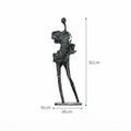 Black abstract sculpture with dimensions on a white background