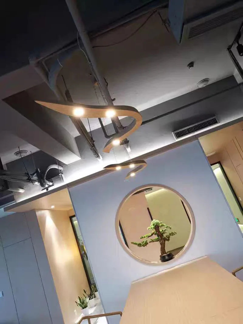 Modern interior design with a round mirror on a light blue wall.